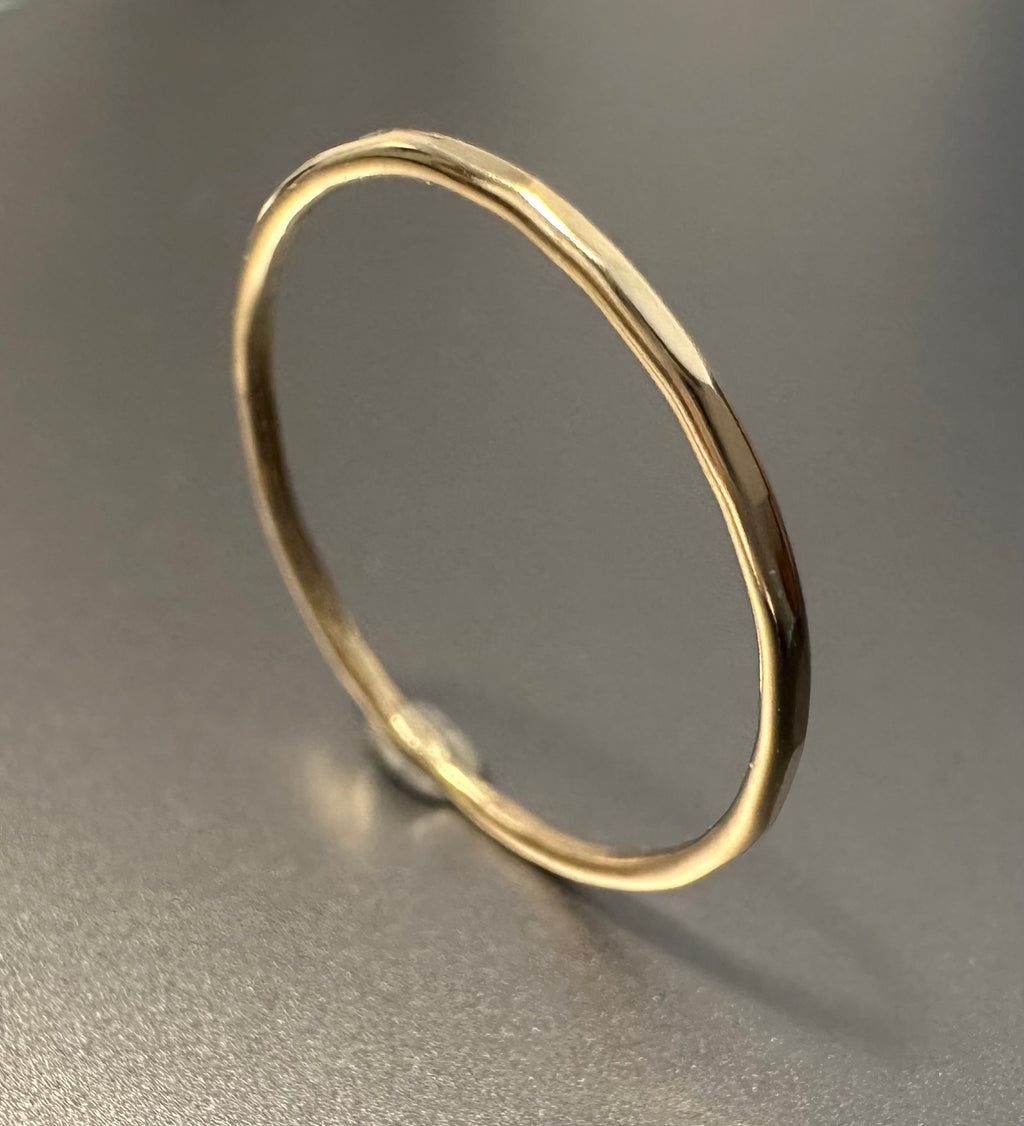 9ct gold hammered stacking ring worn on hand