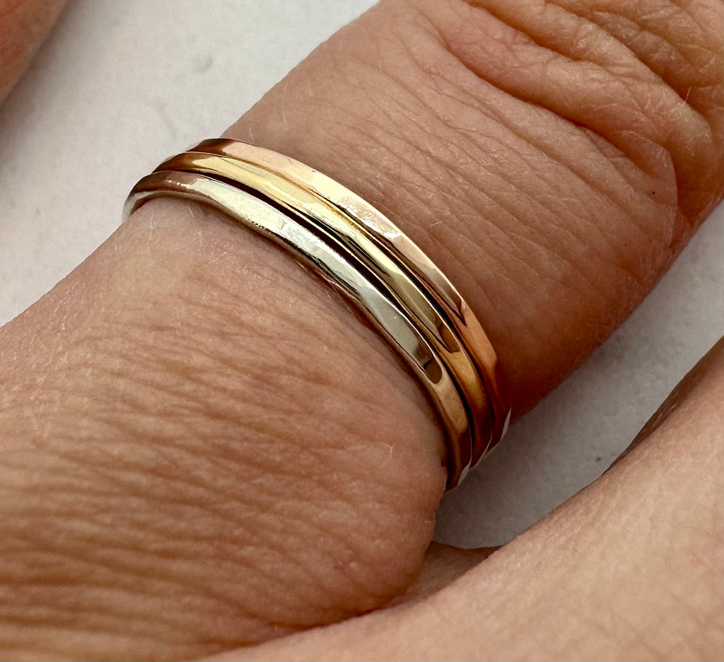 9ct gold hammered stacking ring stacked with other rings