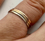 9ct gold hammered stacking ring stacked with other rings