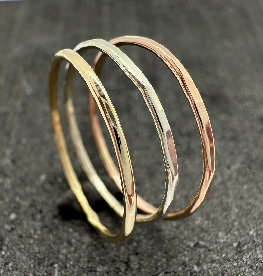 9ct gold hammered stacking ring on finger