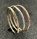 9ct gold hammered stacking ring on finger