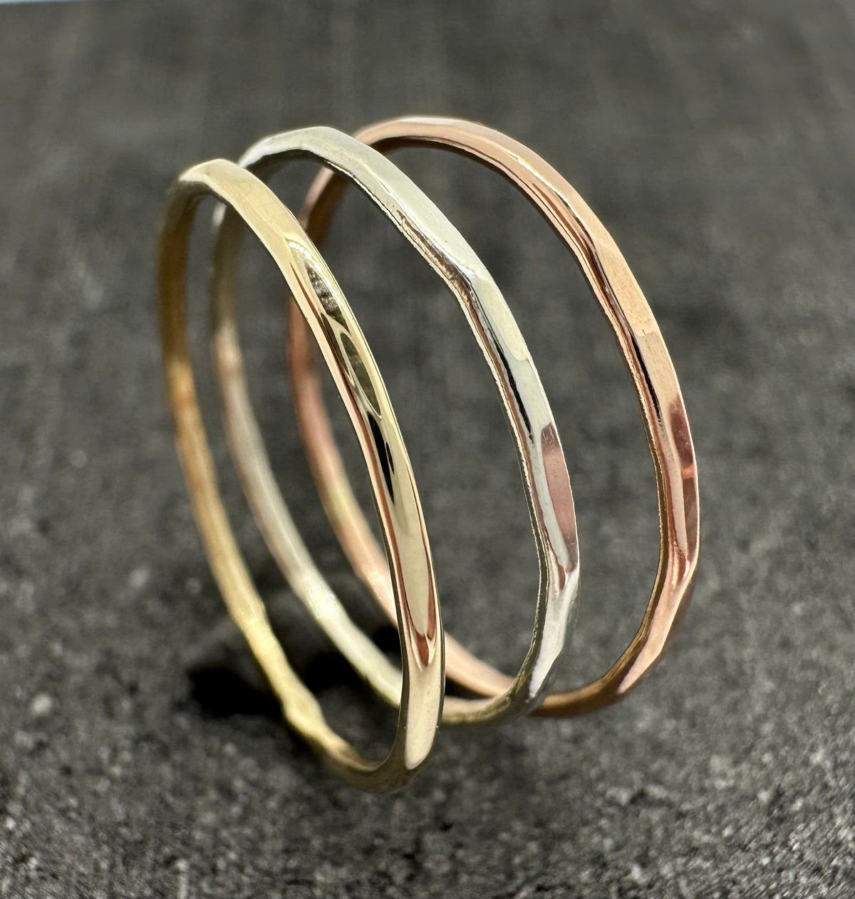 9ct gold hammered stacking ring on finger