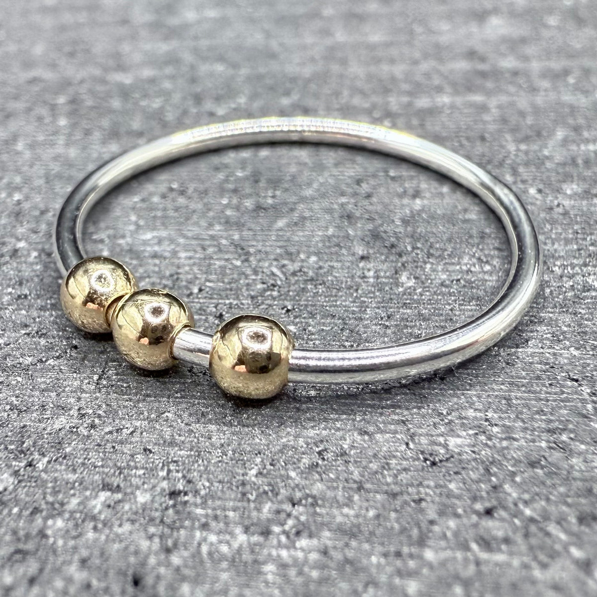9ct gold bead fidget ring worn on hand