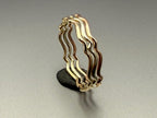 9ct gold wavy stacking ring stacked with other rings