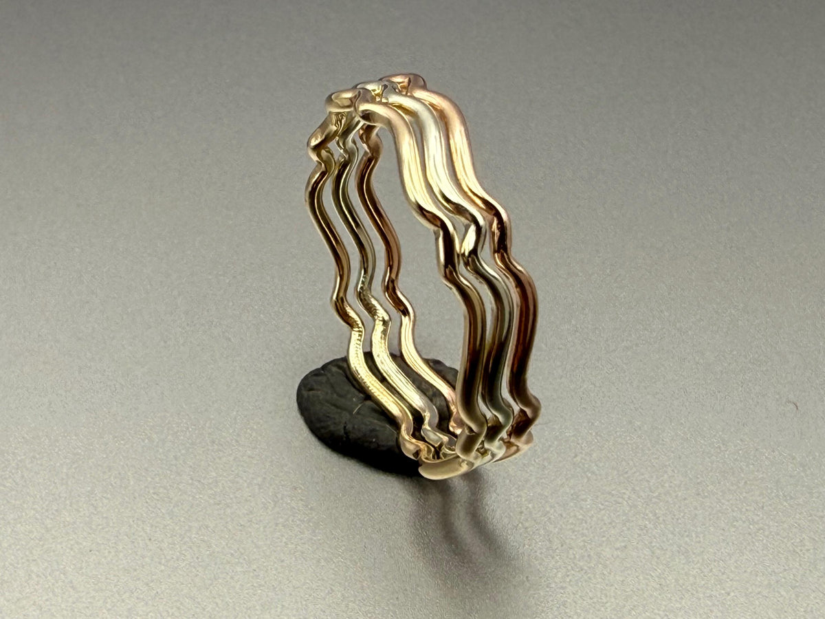 9ct gold wavy stacking ring stacked with other rings