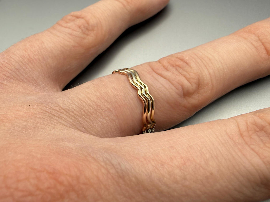 9ct gold wavy stacking ring worn on hand